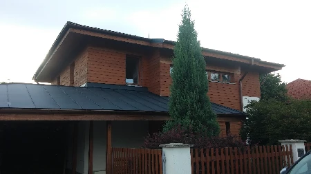 Rodinný dům s tmavou falcovanou plechovou střechou